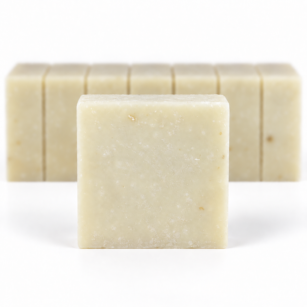 Lavender Greek Yogurt, with a sharp foreground soap bar and a softly blurred row of bars on a white background.