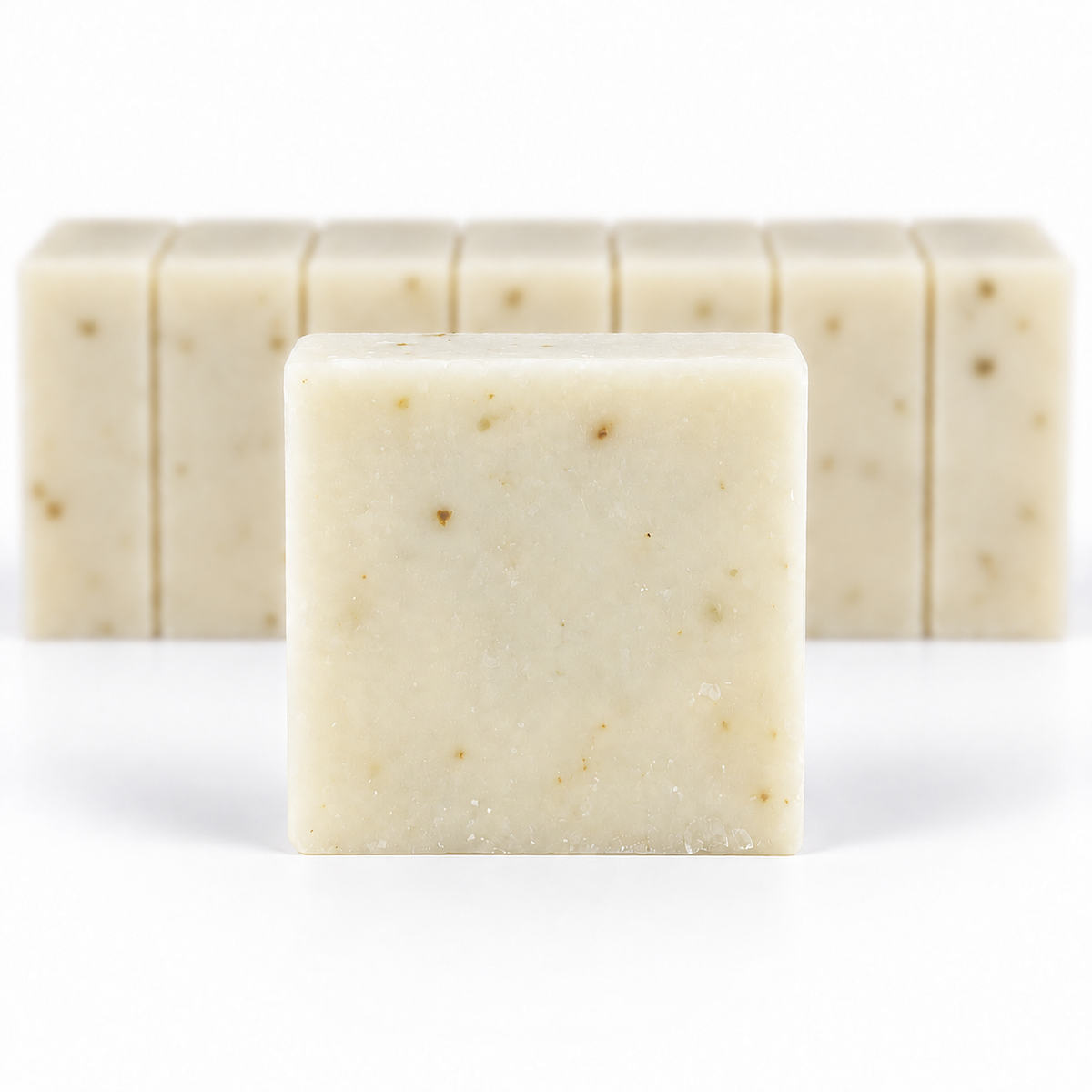Eucalyptus Lavender Goats Milk, with a sharp foreground soap bar and a softly blurred row of bars on a white background.