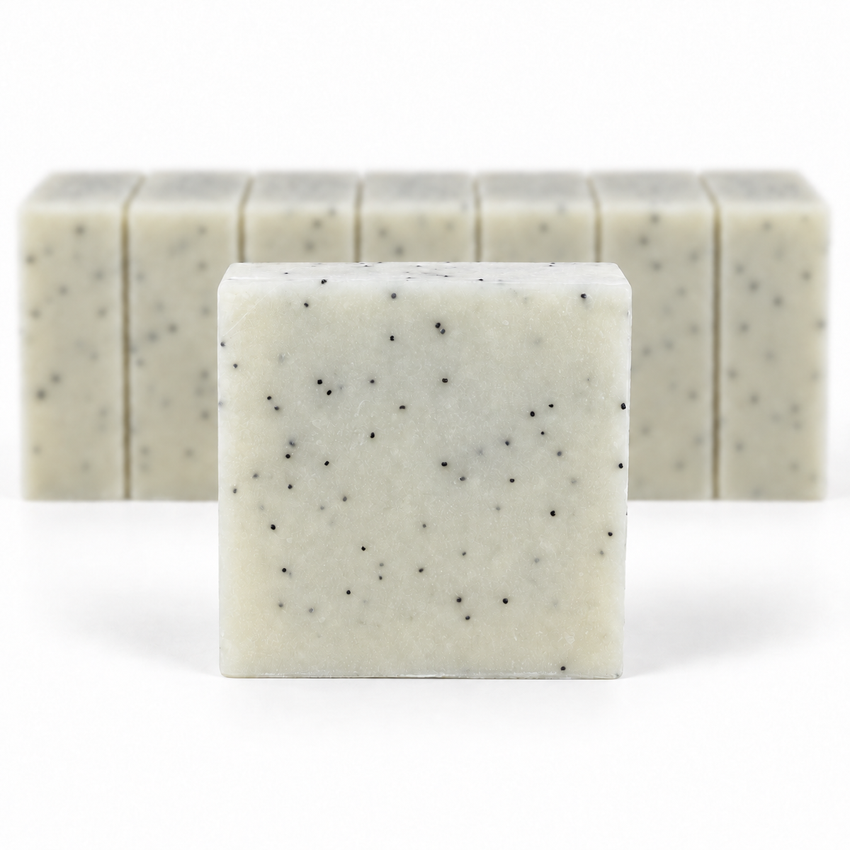 Mechanic's Soap, with a sharp foreground soap bar and a softly blurred row of bars on a white background.