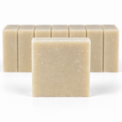 Milk and Collagen with Goat's Milk, with a sharp foreground soap bar and a softly blurred row of bars on a white background.