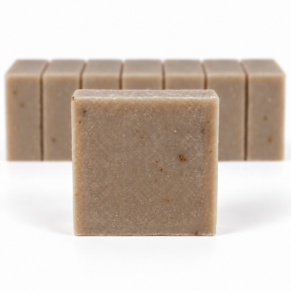 Oatmeal Goat's Milk Soap, with a sharp foreground soap bar and a softly blurred row of bars on a white background.